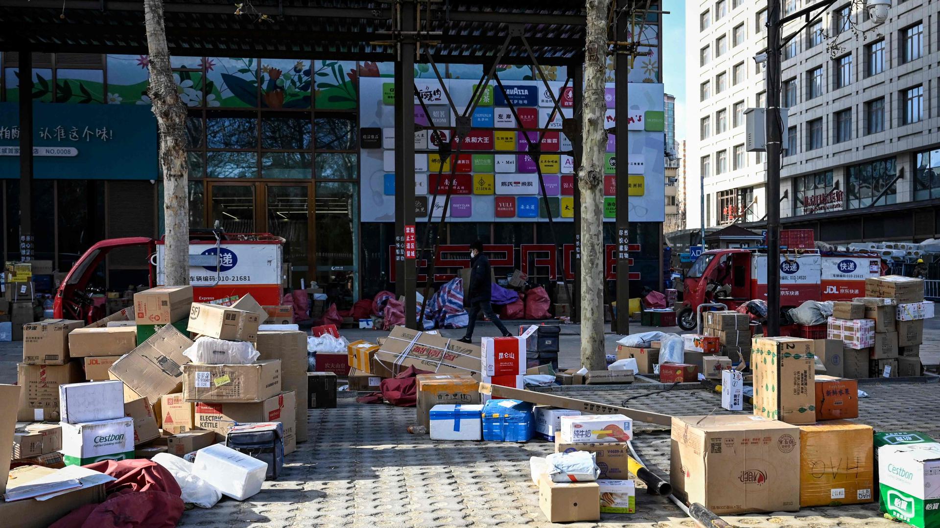 Delivery parcels are stacked along a street amid the Covid-19 pandemic in Beijing on 17 December 2022