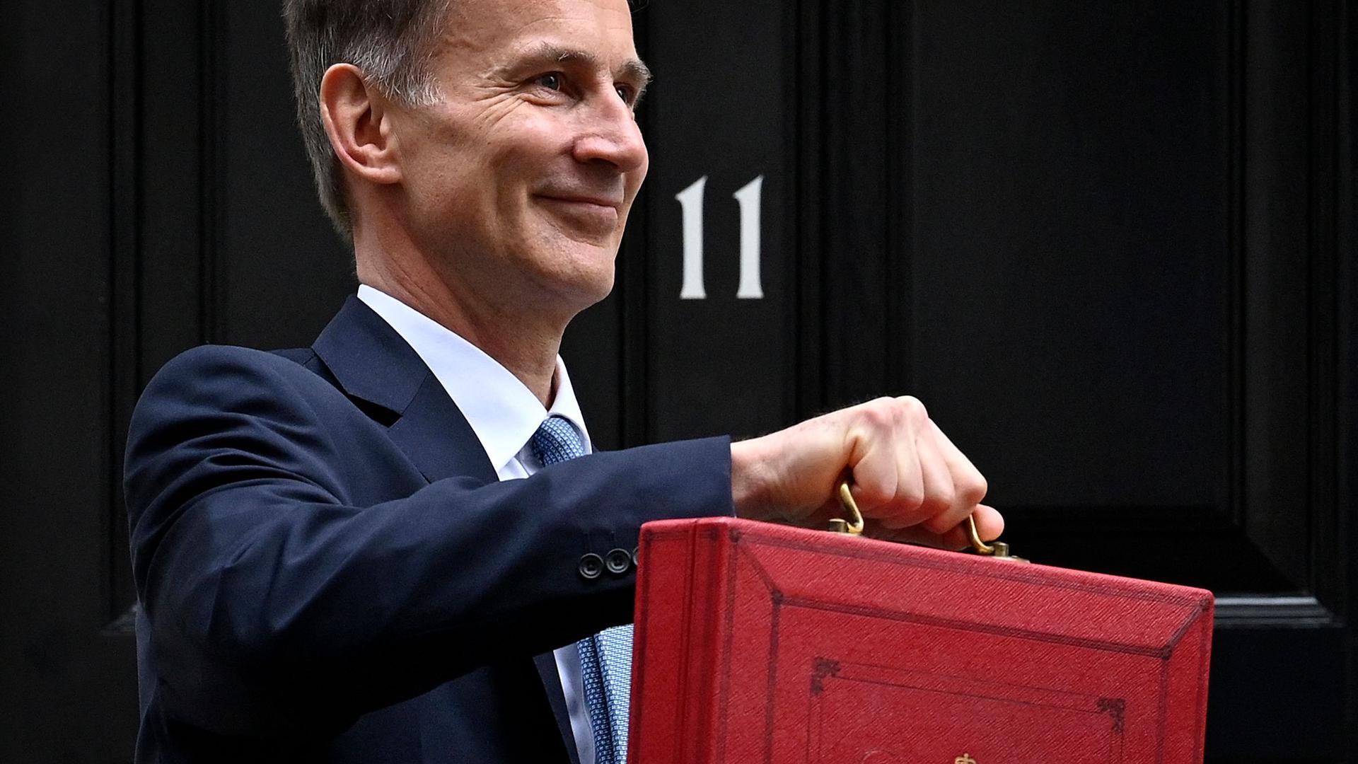 Chancellor of the Exchequer Jeremy Hunt poses with the red Budget Box as he leaves 11 Downing Street