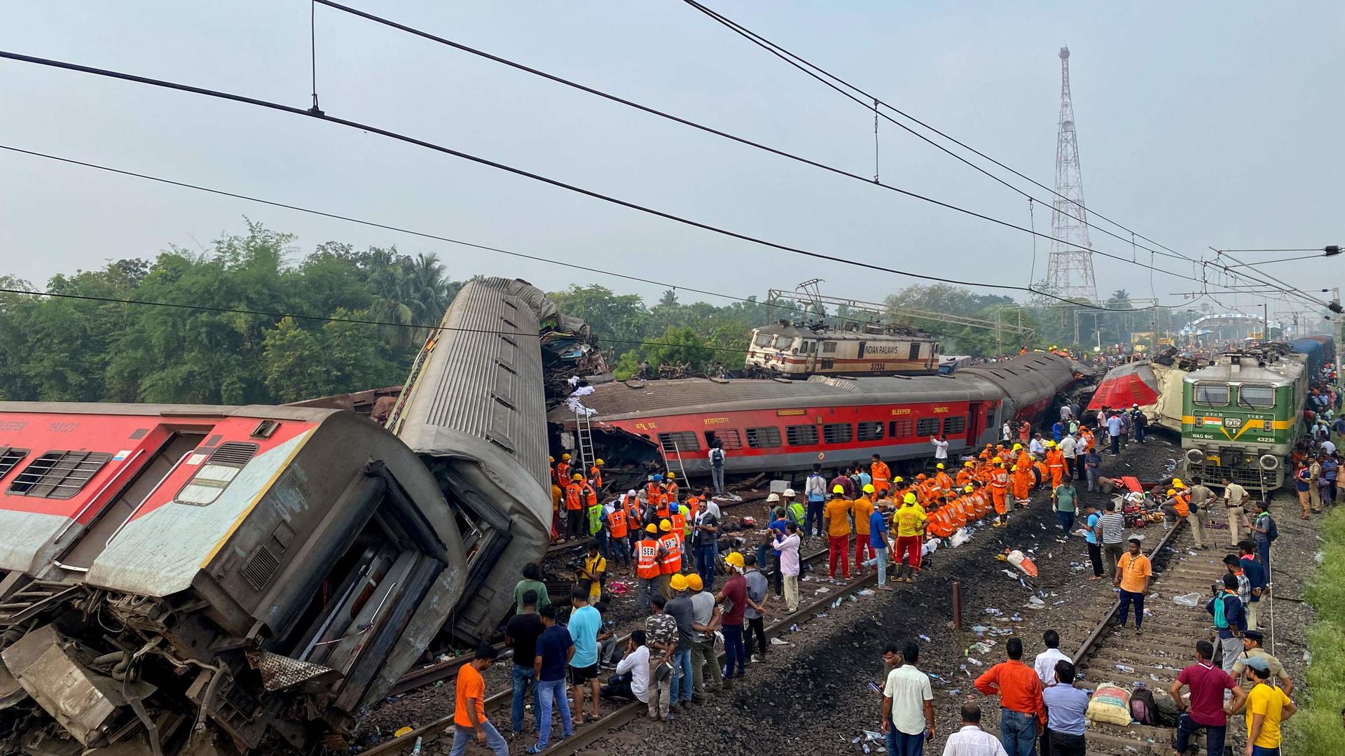 Rescue workers search for survivors at the accident site of a three-train collision in eastern India's Odisha state