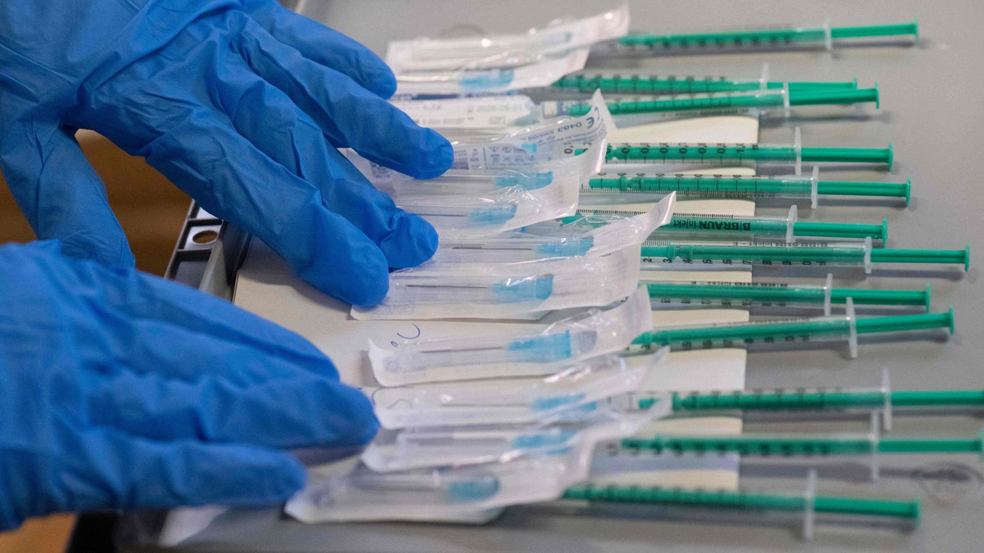 Syringes filled with the BioNtech-Pfizer Covid-19 coronavirus vaccine are being prepared in a mobile vaccination center in Hemmingen, Germany, on Tuesday