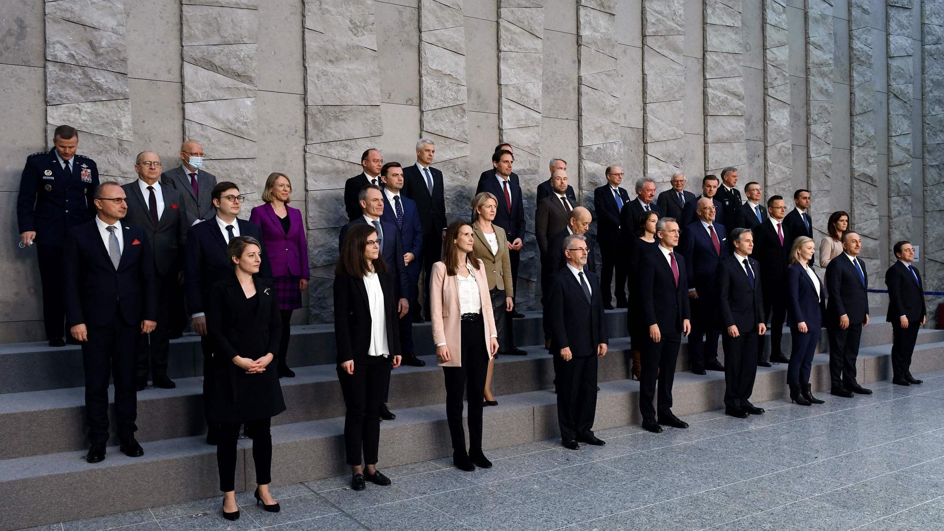 NATO Secretary General Jens Stoltenberg (front row 5th L) stands next to US Secretary of State Antony Blinken (front row- 6th L) and members of the North Atlantic Council (NAC) and Foreign Ministers as they pose for a family photo at the NATO Headquarters in Brussels on March 4, 2022. - 