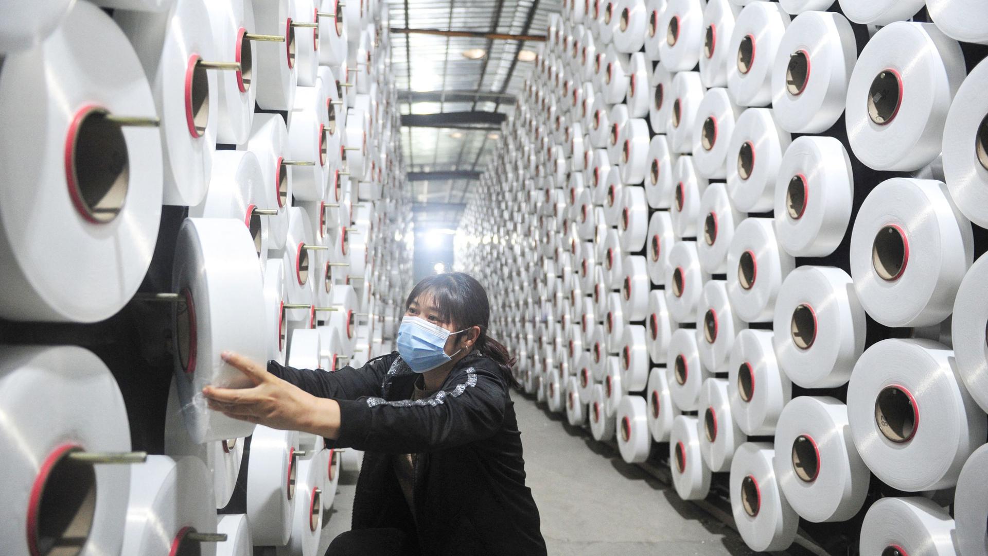 A textile factory worker in Hangzhou in China's eastern Zhejiang province on Sunday
