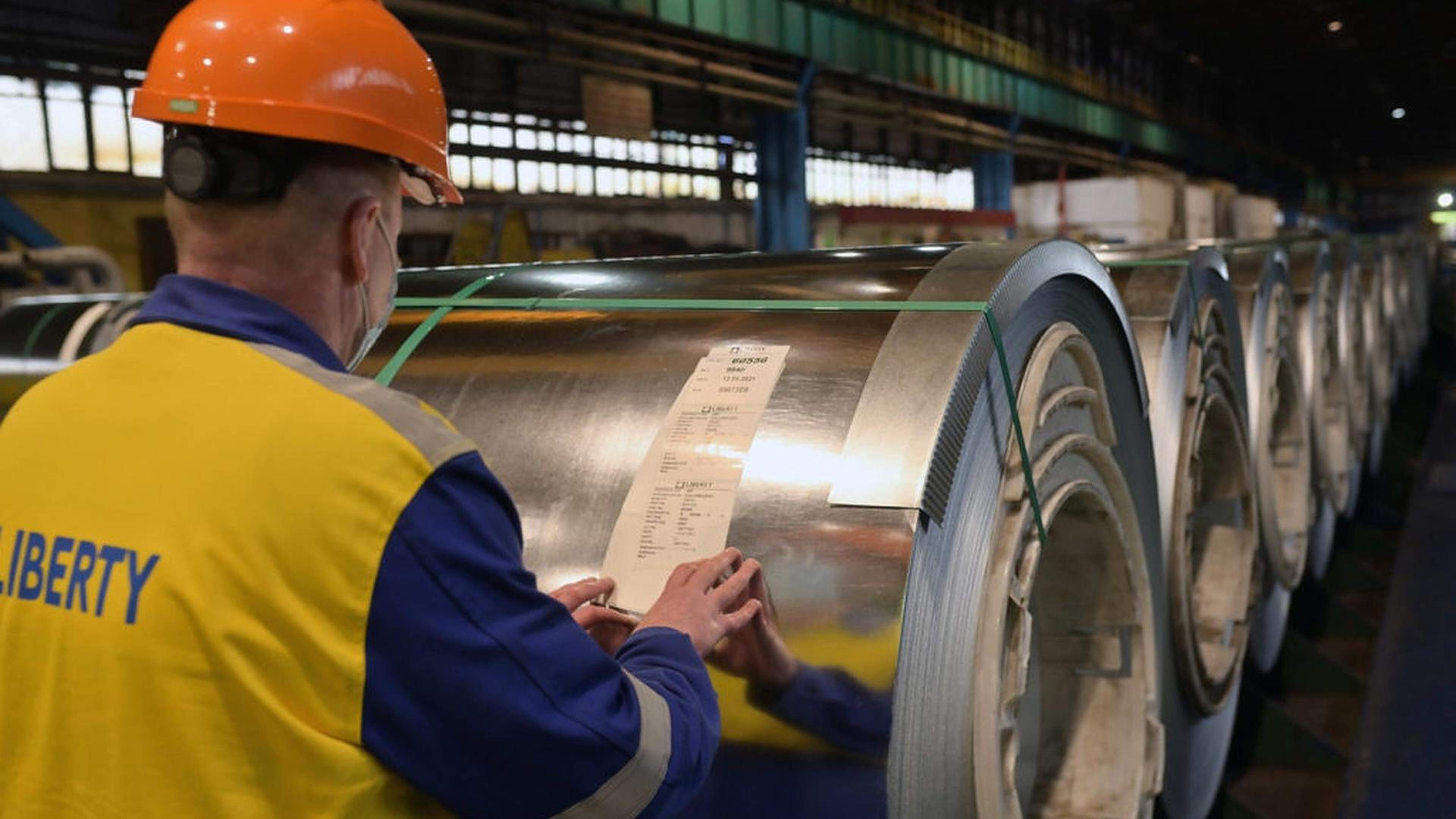 A Liberty Steel worker checks rolled steel at the company’s Belgian factory