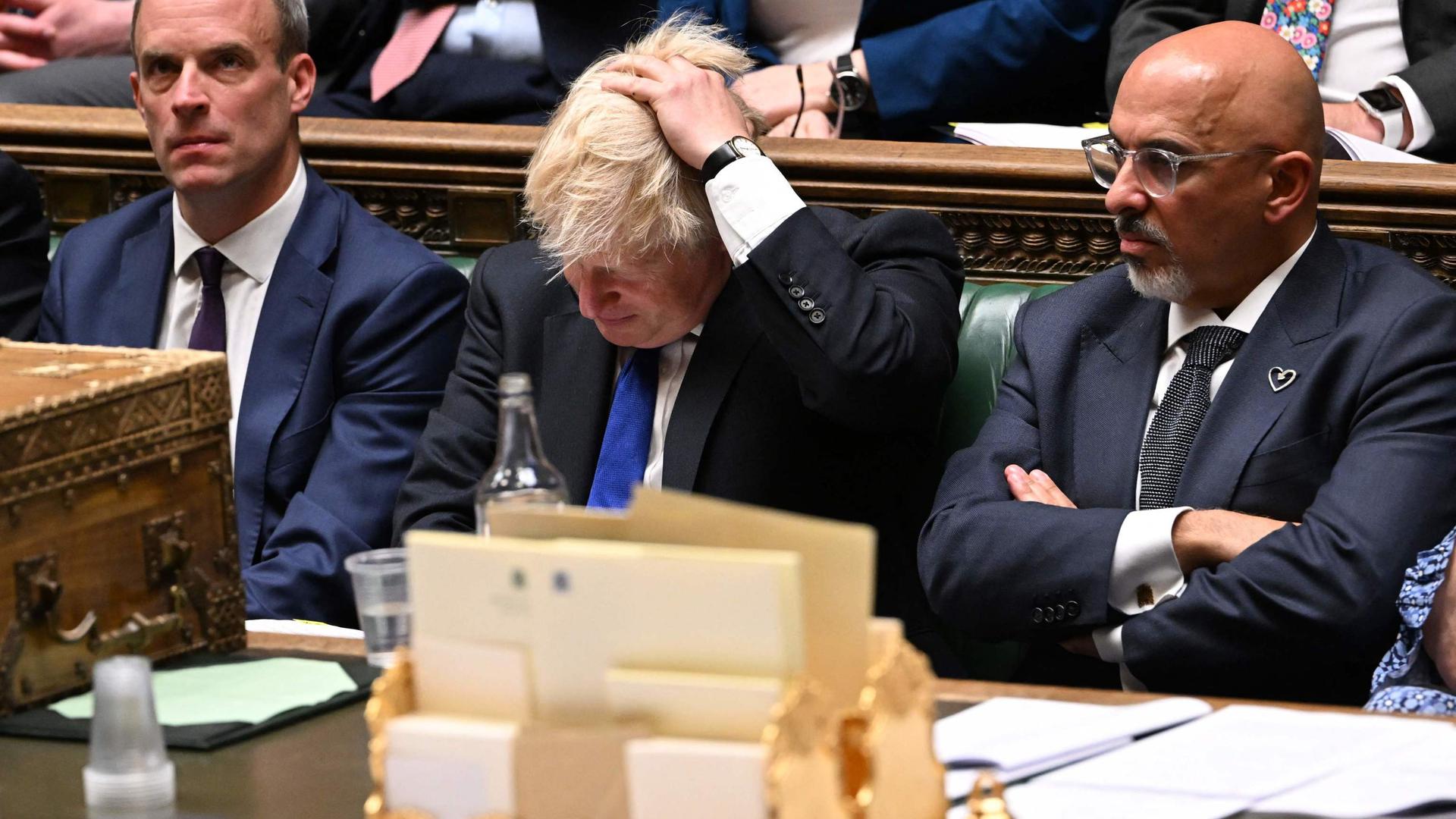 Boris Johnson flanked by Justice Secretary Dominic Raab (L) and Britain's new Chancellor of the Exchequer Nadhim Zahawi (R) during prime minister's questions on July 6, 2022