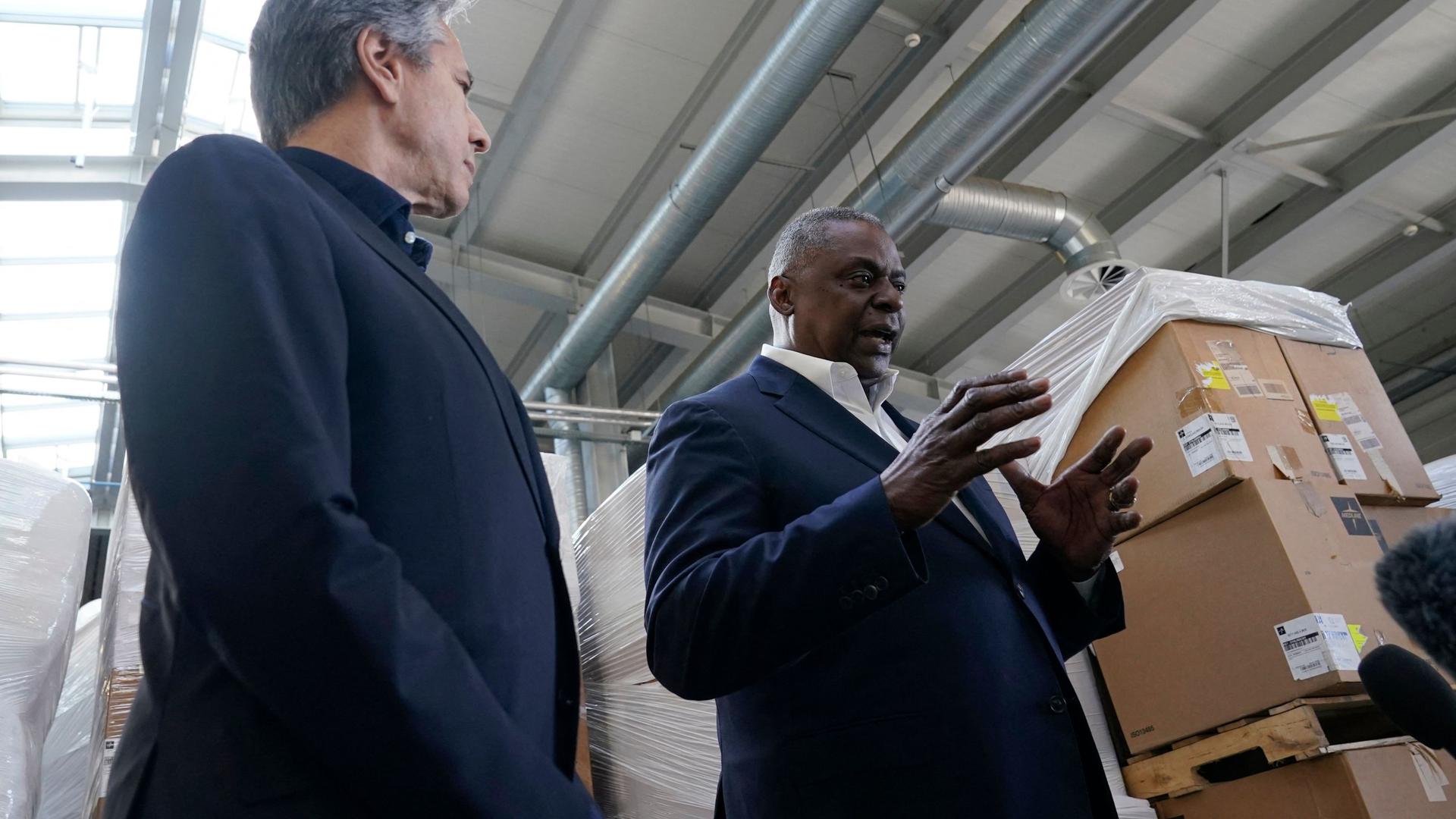 Pallets of aid to Ukraine are stacked behind US Defense Secretary Lloyd Austin (R) and Secretary of State Antony Blinken (L) as they speak with reporters after returning from their trip to Kyiv, Ukraine, on Sunday.