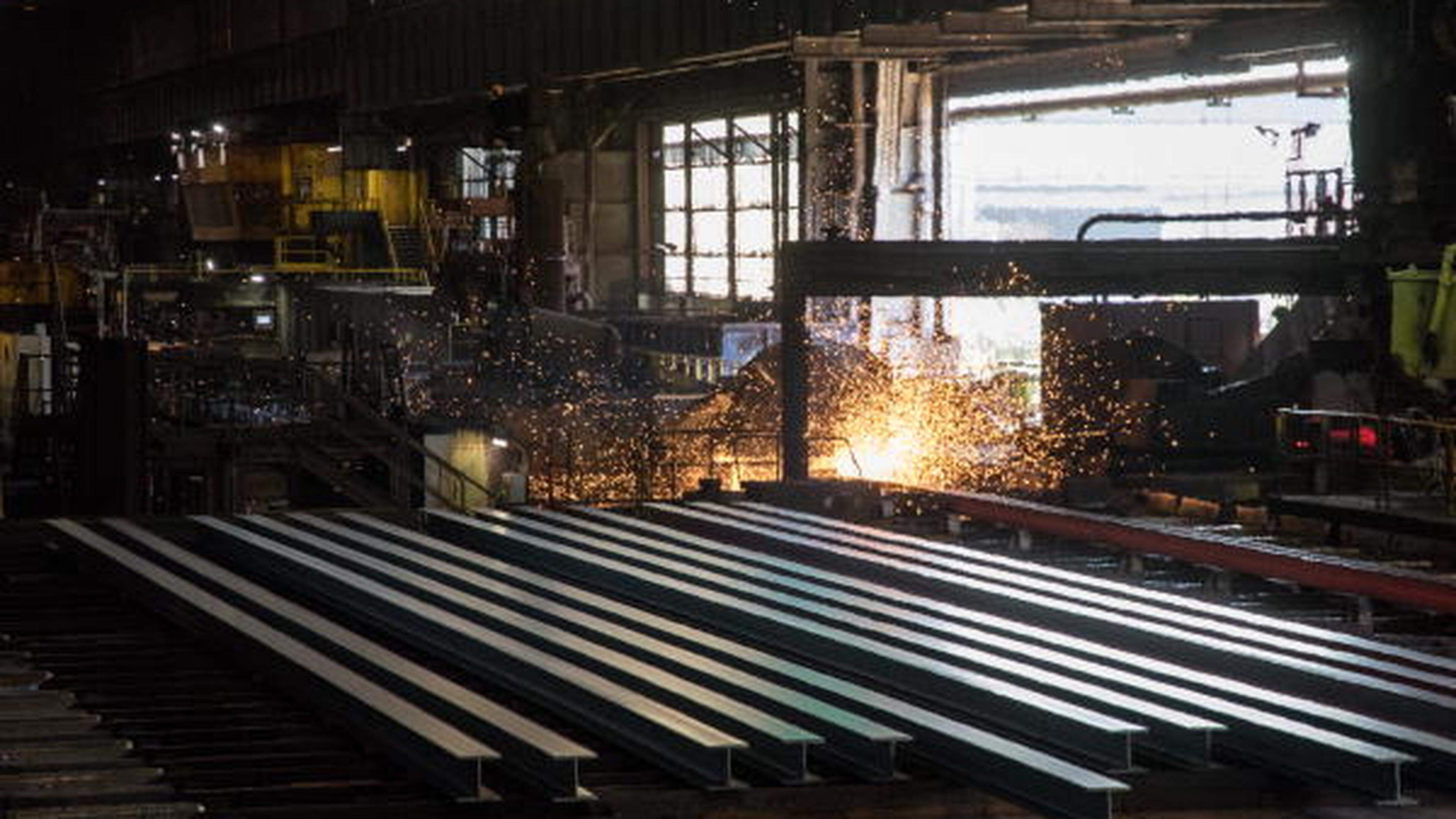 Workers prepare steel rails at the ArcelorMittal factory in Differdange
