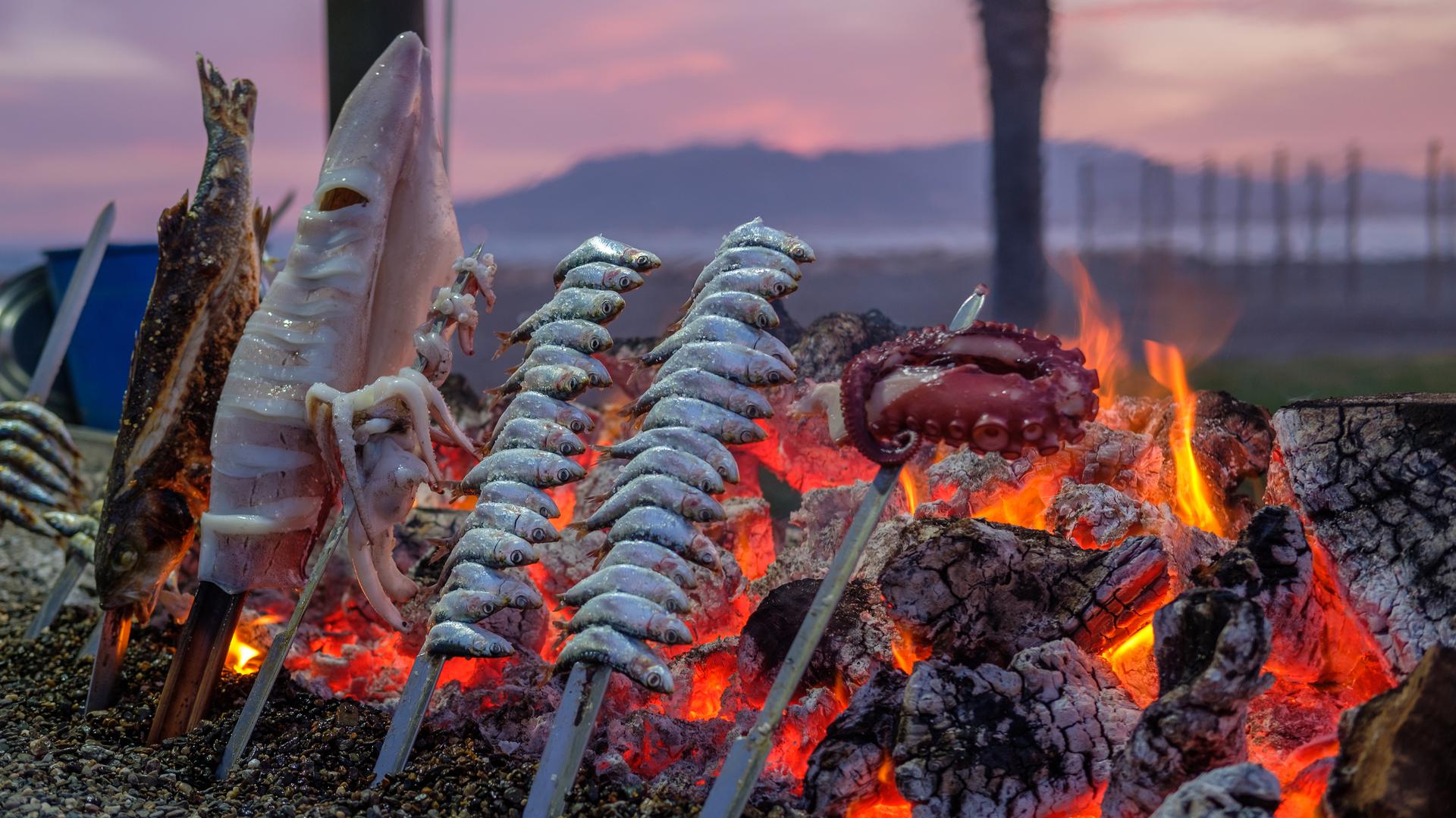 Sardines Espetos cooked on an open fire is a culinary speciality of Malaga