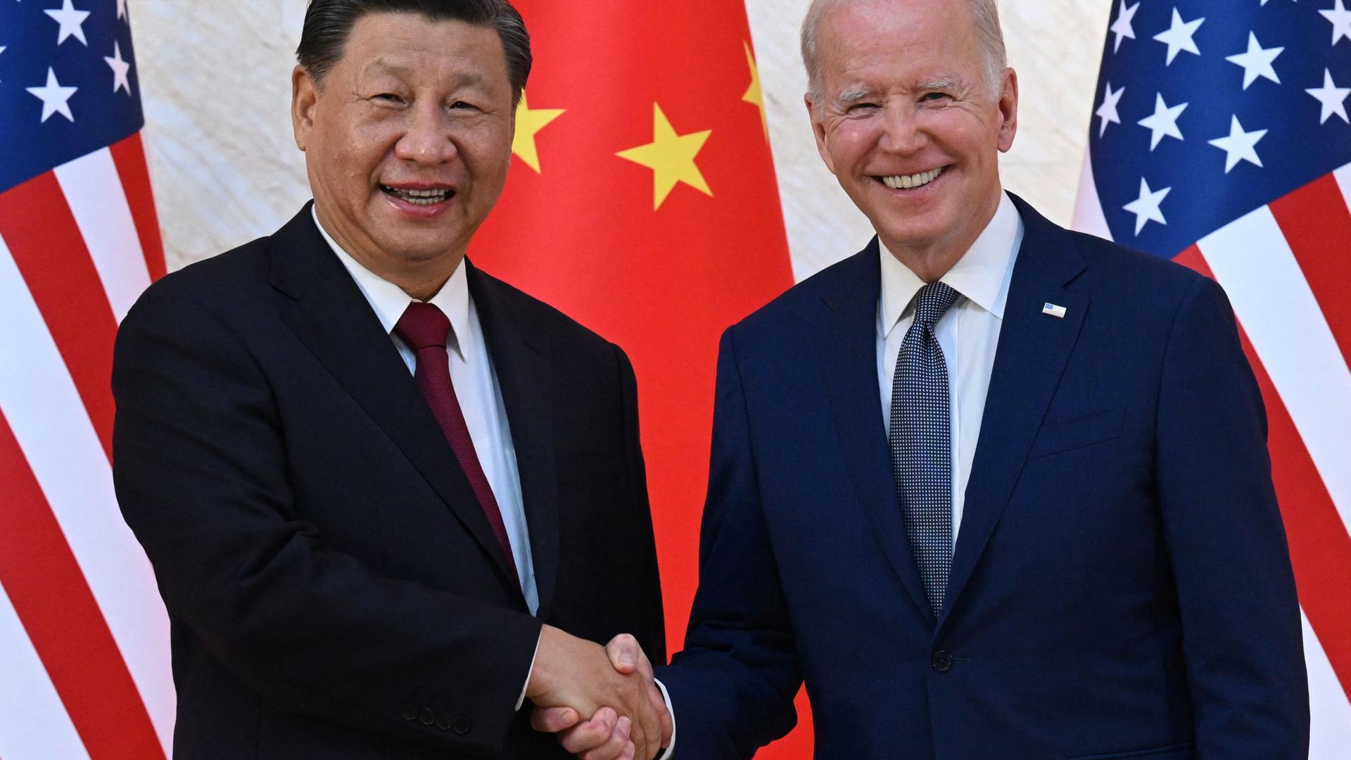 US President Joe Biden and China's President Xi Jinping shake hands as they meet on the sidelines of the G20 Summit in Bali on Monday