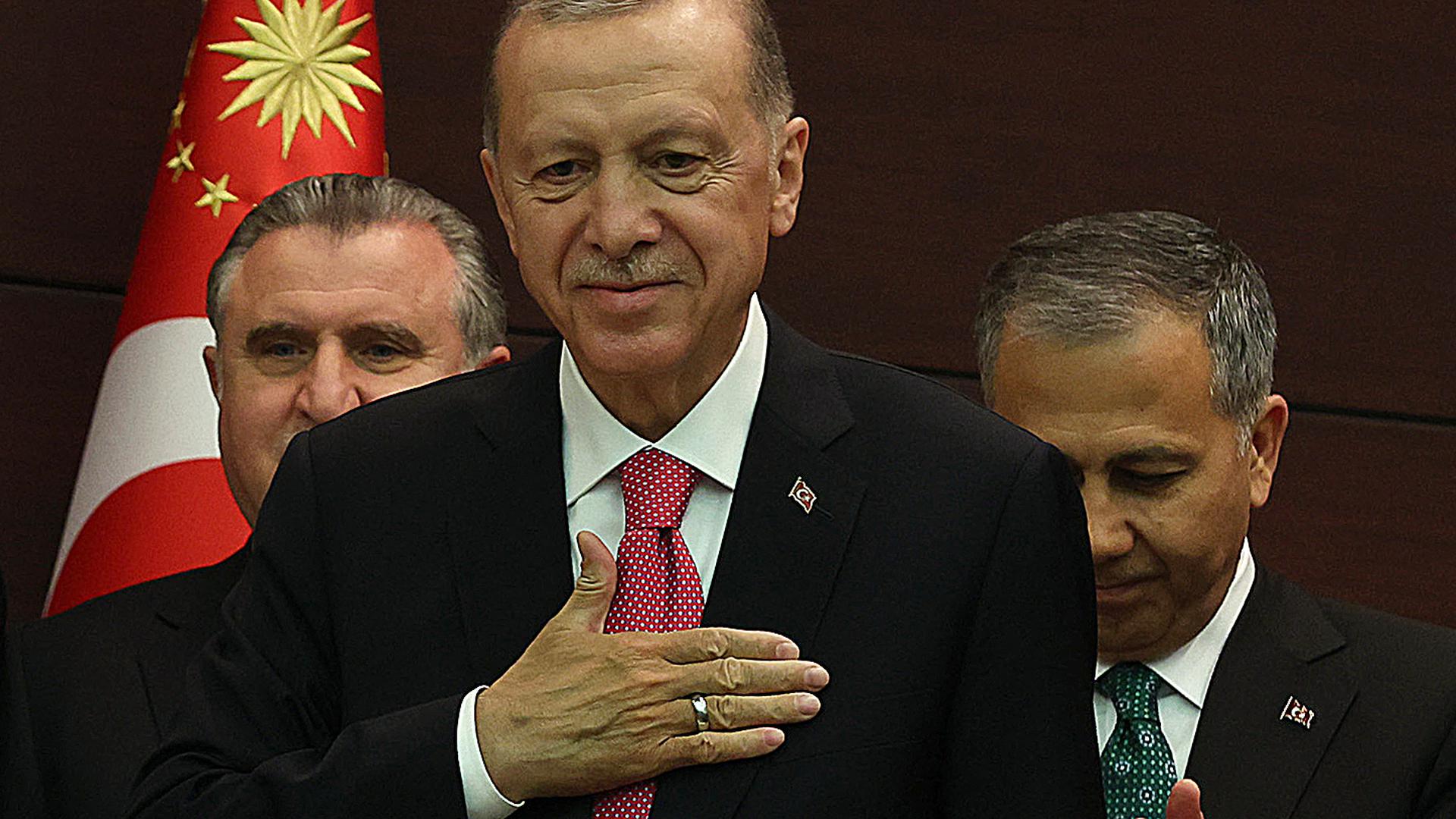 Turkey's President Recep Tayyip Erdogan gestures next to Turkey's new Interior Minister Ali Yerlikaya (right) as he unveils the country's new cabinet