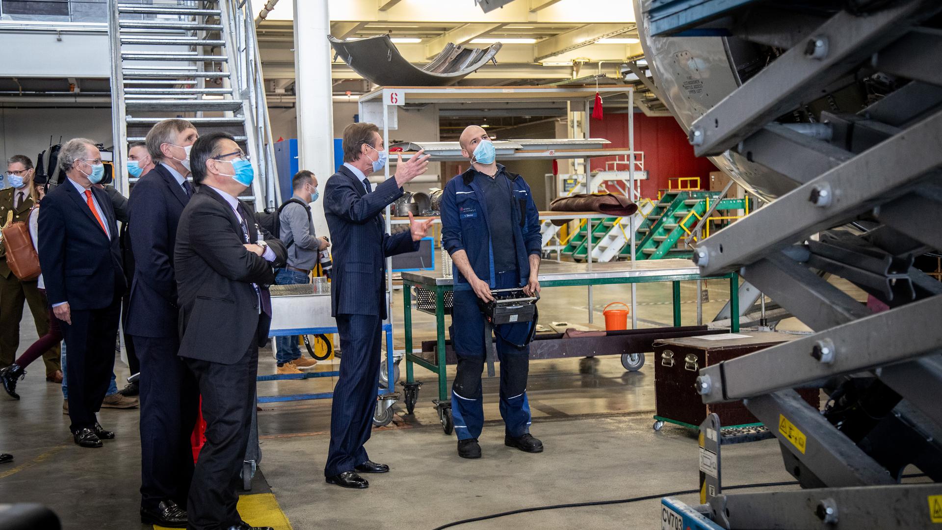 Transportation Minister François Bausch (second from left), Cargolux CEO Richard Forson (third from left) and Grand Duke Henri (centre) inspect the state's investment in Cargolux during a tour of the cargo airlines maintenance hangar in February