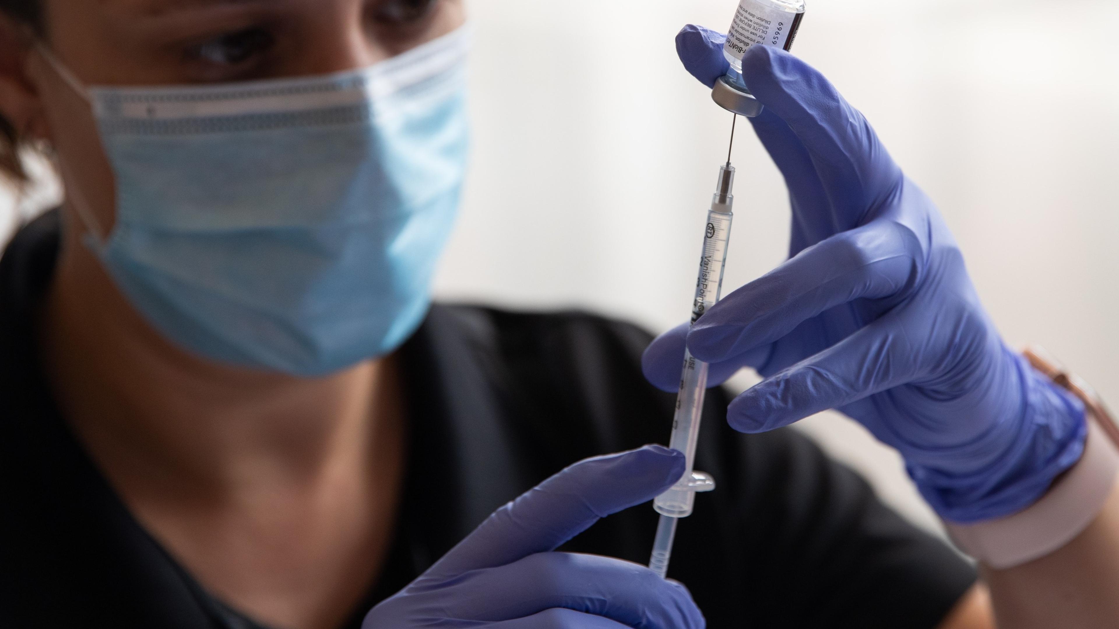 A healthcare worker prepares a Covid-19 vaccine