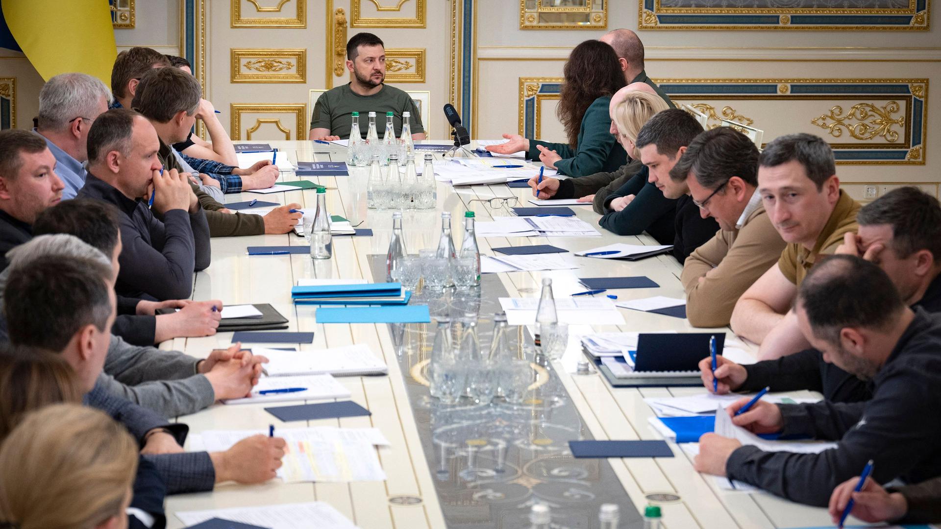 This handout picture taken and released by the Ukrainian Presidential press service on May 27, 2022 shows Ukrainian President Volodymyr Zelensky (C) chairing a meeting with members of the Ukrainian government in Kyiv