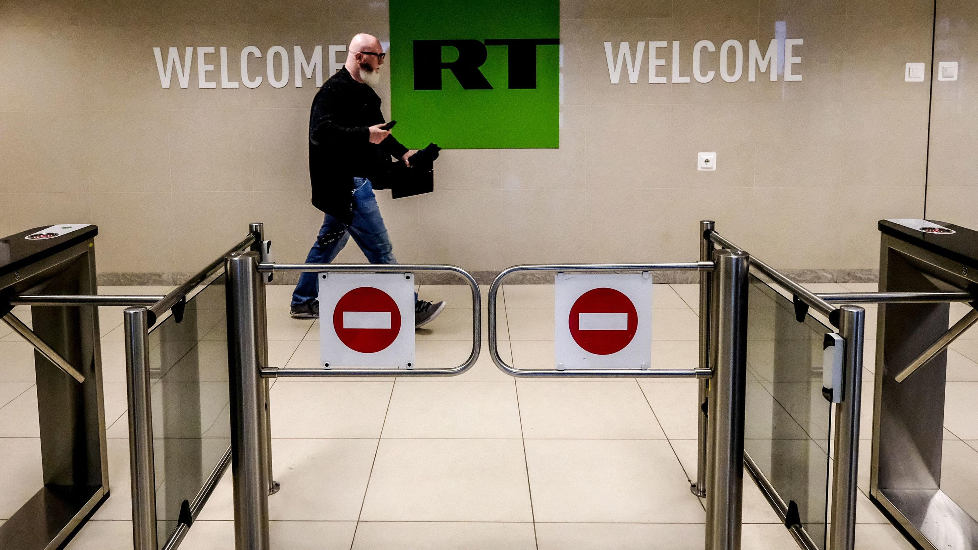 A man walks past a control post at the Russia Today (RT) TV company in Moscow in June 2018