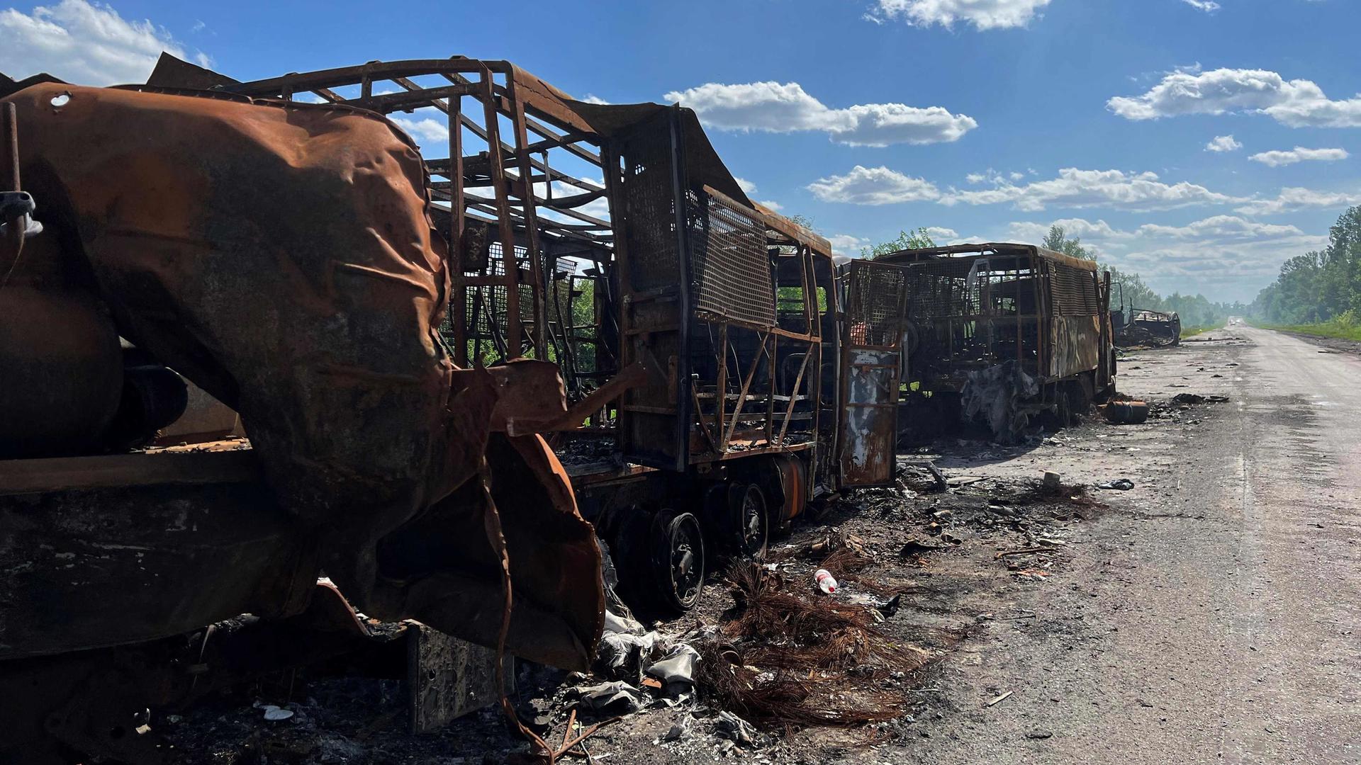 This photograph taken on 27 May 2022, shows Russian military vehicles destroyed on a road near the village of Kutuzivka,  Kharkiv region, amid the Russian invasion of Ukraine