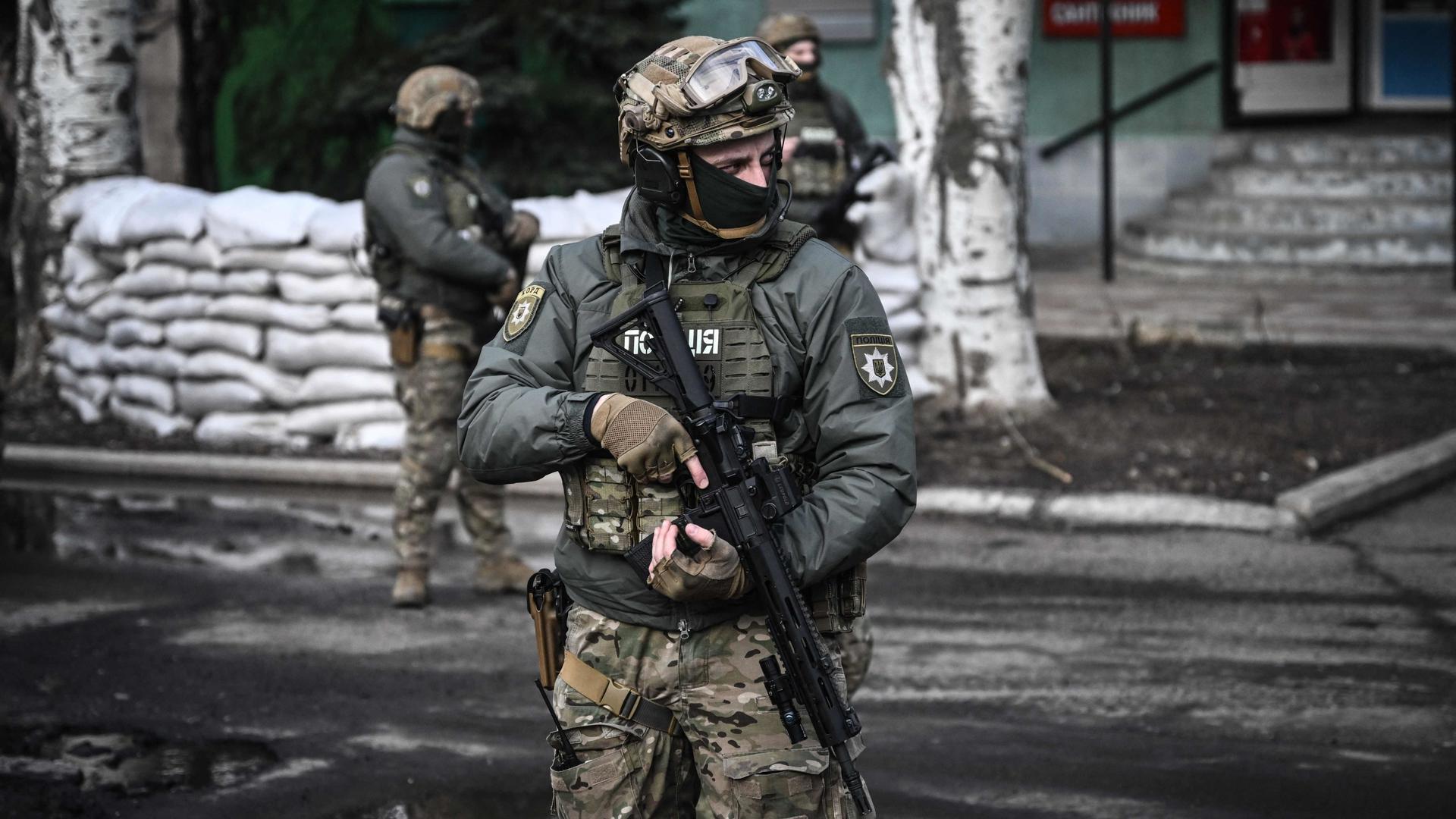 Ukrainian troops patrol in the town of Novoluhanske, eastern Ukraine, on February 19, 2022