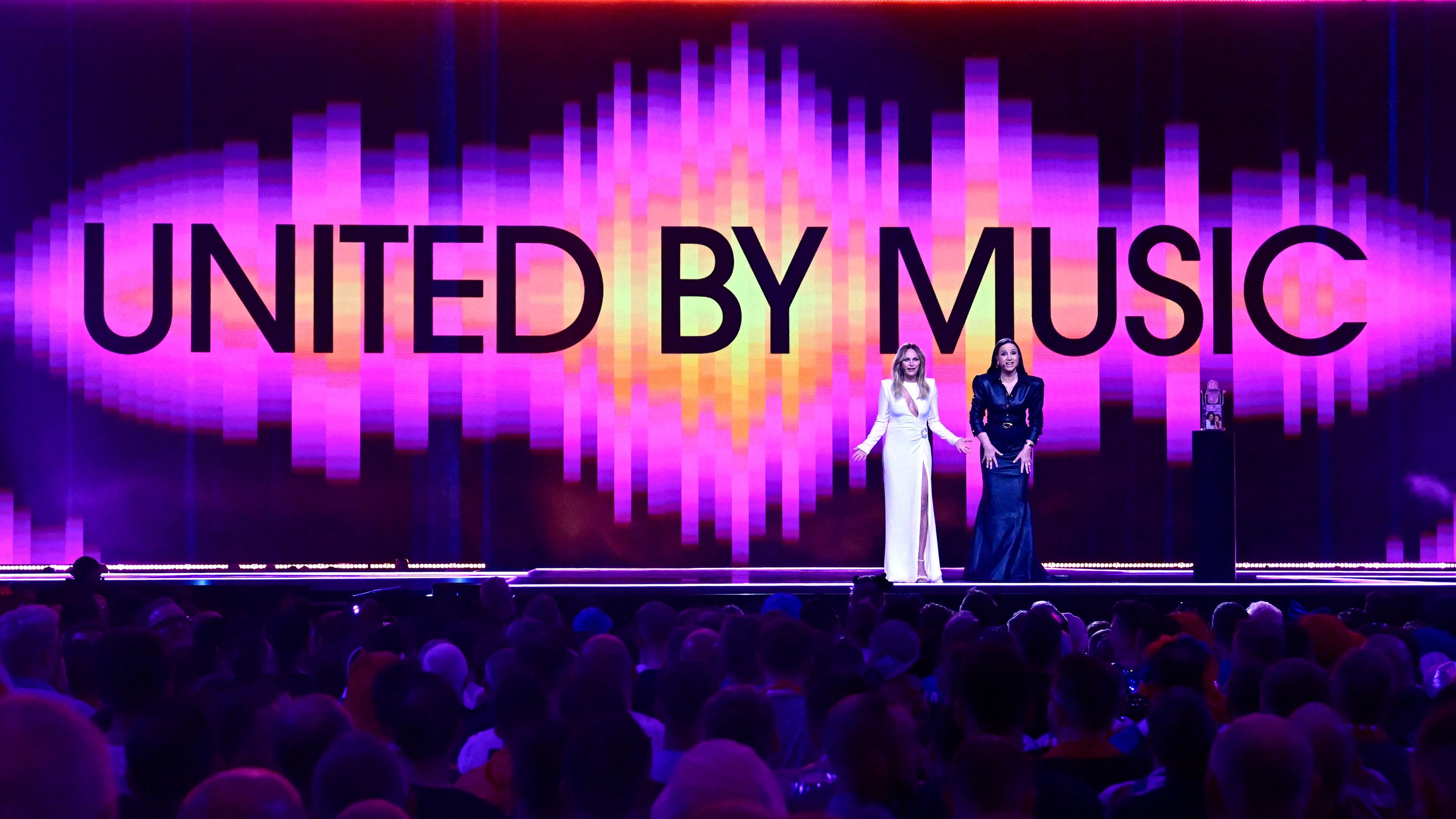 Swedish-US actress and presenter Malin Akerman (L) and Swedish actress and presenter Petra Mede stand on stage at the start of the final of the 68th Eurovision Song Contest (ESC) 2024 on May 11, 2024 at the Malmo Arena in Malmo, Sweden. (Photo by Tobias SCHWARZ / AFP)